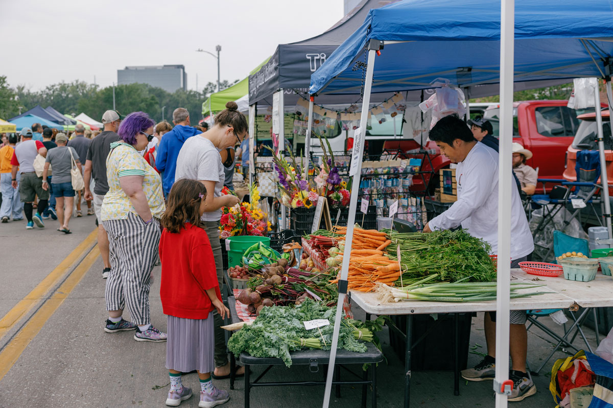 People looking at Omaha Farmers Market Aksarben Village booths