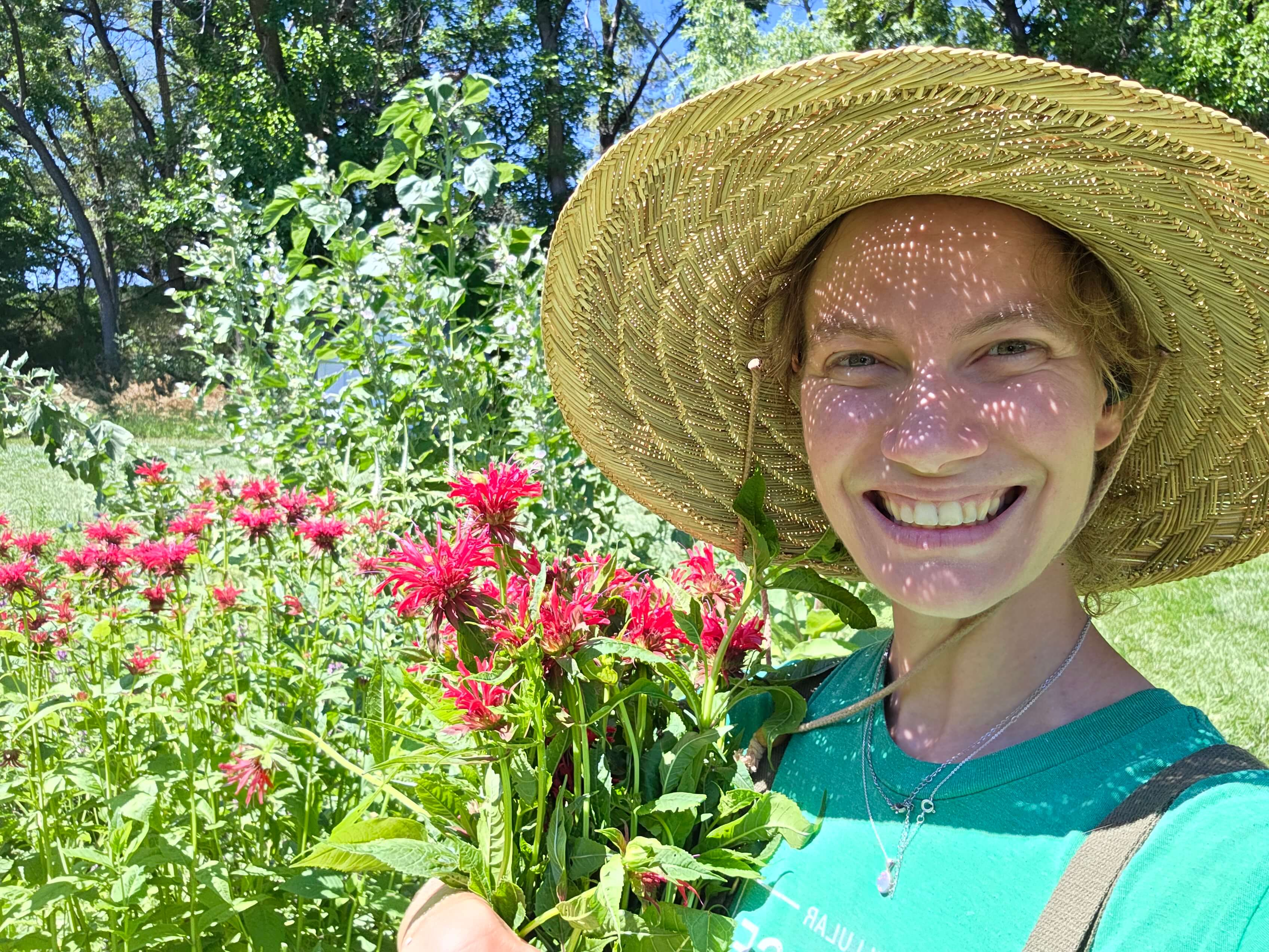 Starflower botanicals owner holding flowers in a field